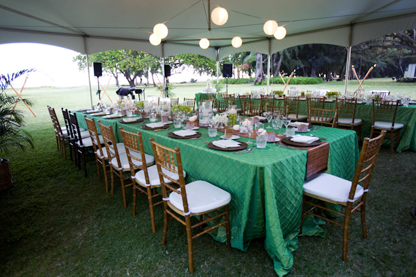 Sage green table cloths with Chiavari chairs in an open sided tent - wedding photo by Melissa Jill Photography